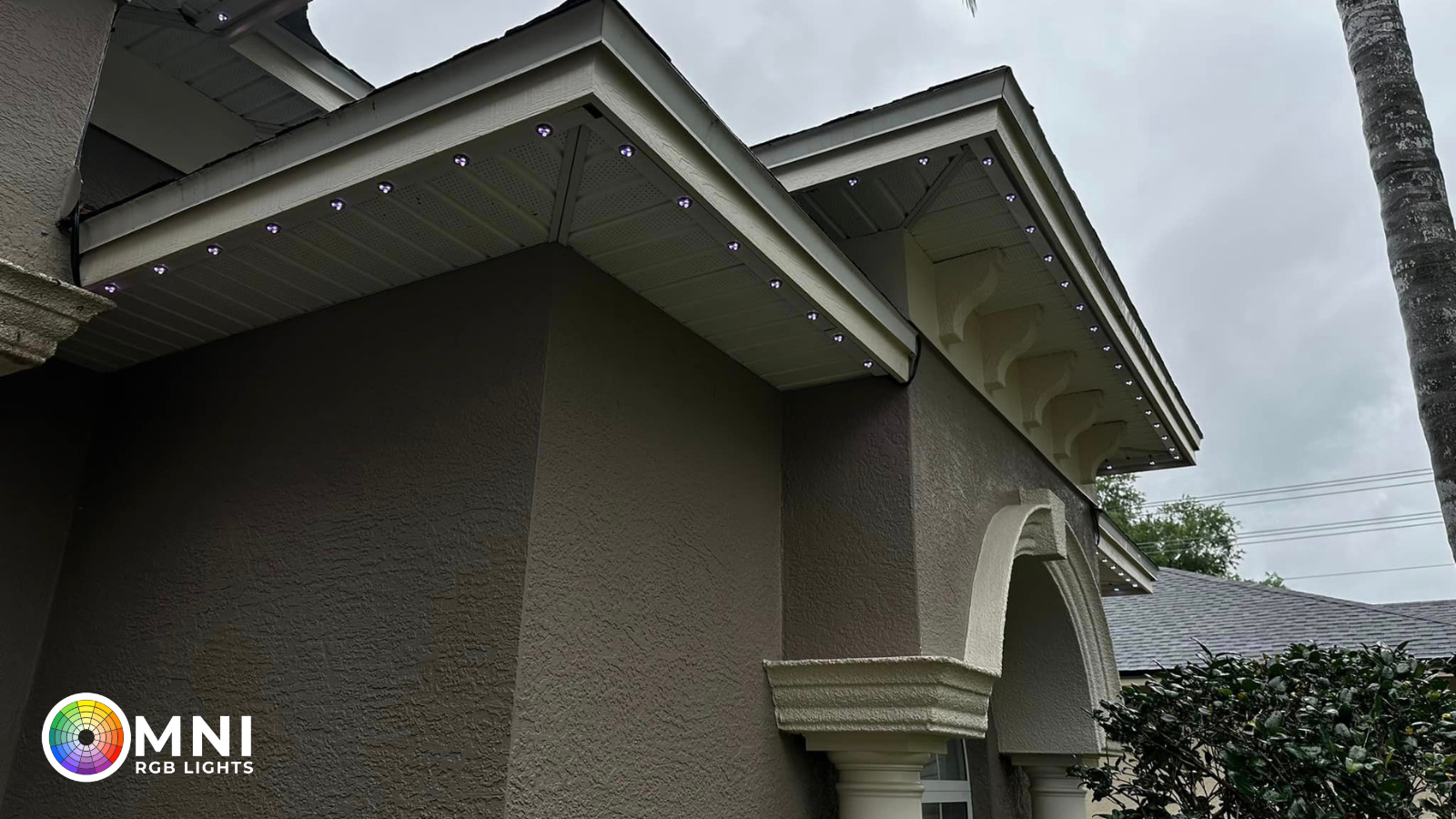 Close-up of discreet permanent outdoor lighting track installed beneath a residential roofline
